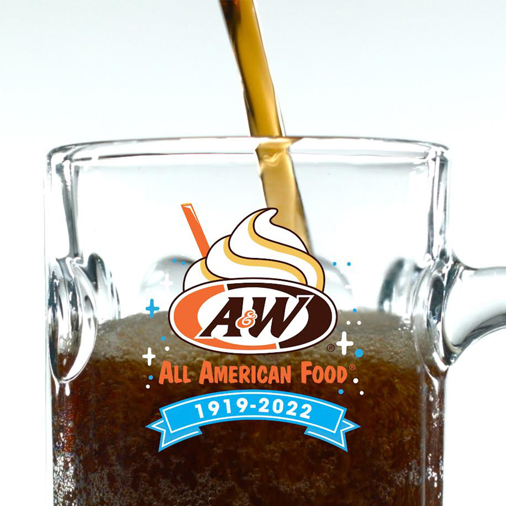 A&W Root Beer Mug filled with Root Beer. The A&W Restaurants logo is in the top center of the mug featuring artwork of an orange straw and soft serve on top.