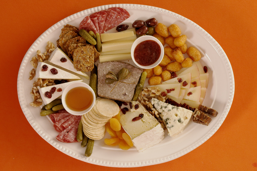 Overhead photo of Holiday Char-curd-erie Board on an orange background.