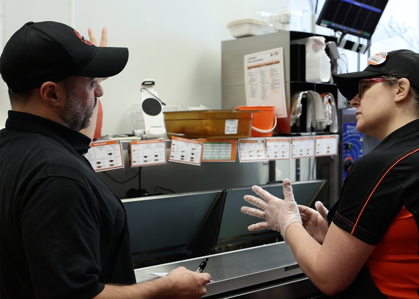 Trainer Paul talking to AWU Attendee in the A&W Test Kitchen