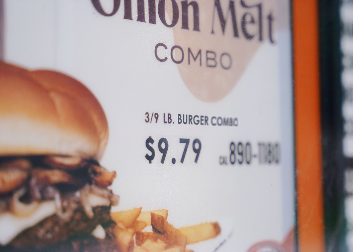 Close-up photo of a Mushroom Onion Melt Combo poster. Text on top of poster reads 