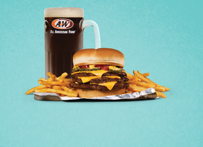 Triple Cheeseburger, fries, and mug of A&W Root Beer on teal background