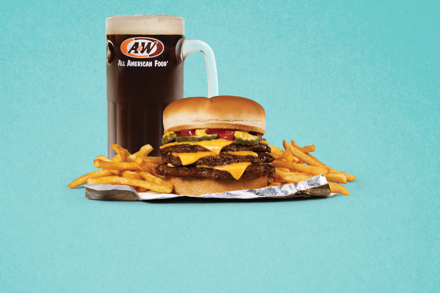 Triple Cheeseburger, fries, and mug of A&W Root Beer on teal background