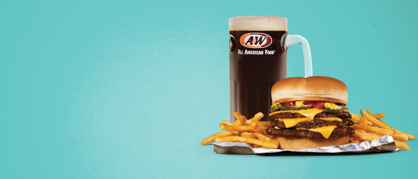 Triple Cheeseburger, fries, and mug of A&W Root Beer on teal background